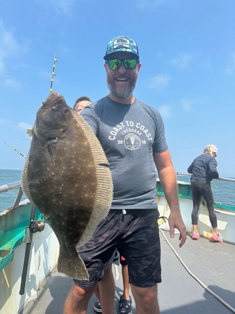 a man holding a fish