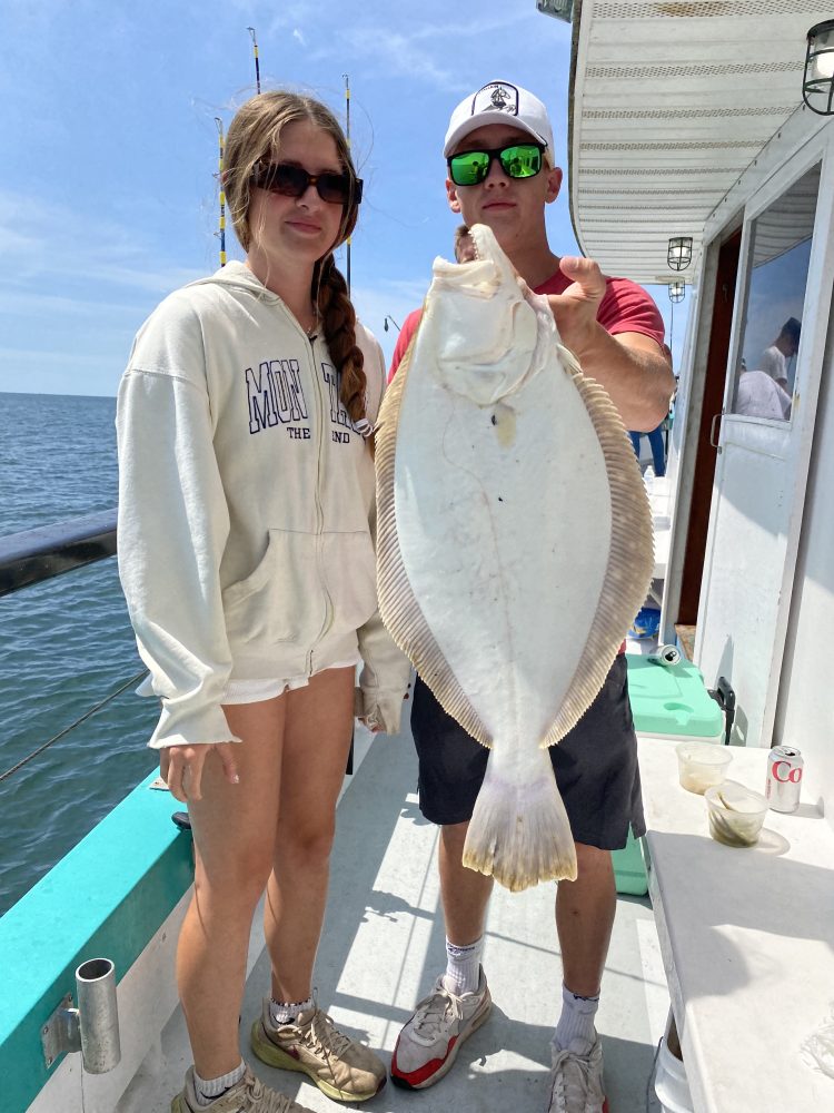 a person holding a fish in the water