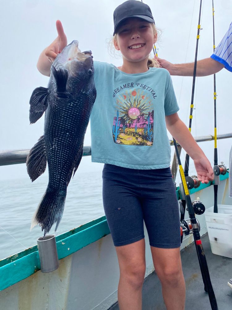 a woman holding a fish