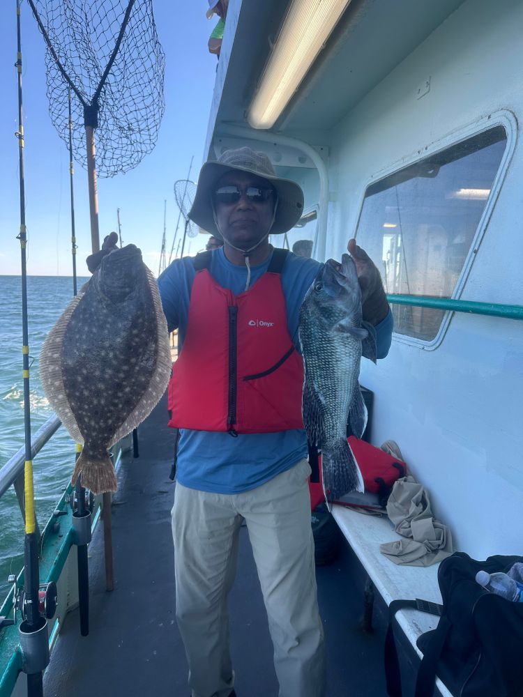 a person holding a fish posing for the camera