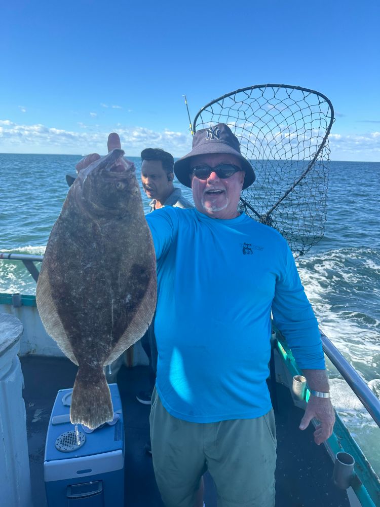 a man holding a fish in the water