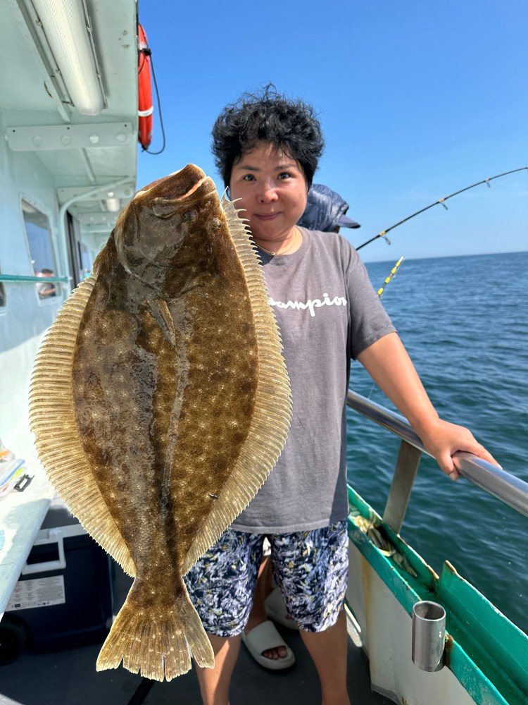 a person holding a fish on a boat