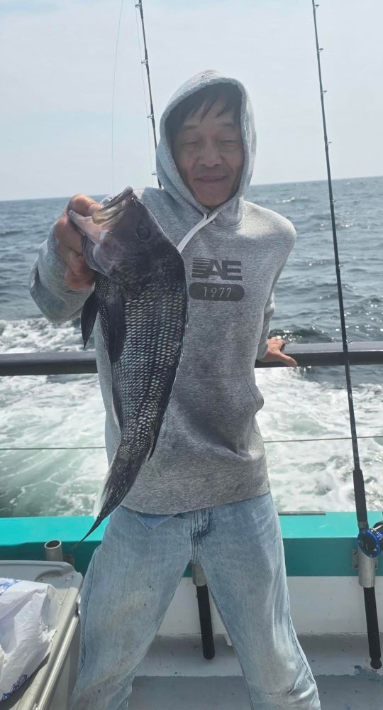 a man holding a fish in the water