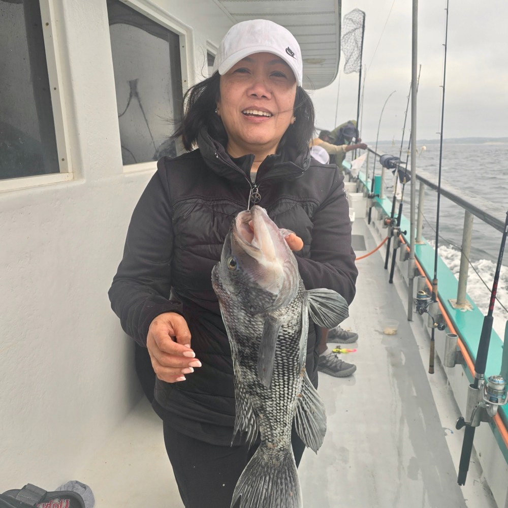 a woman holding a fish