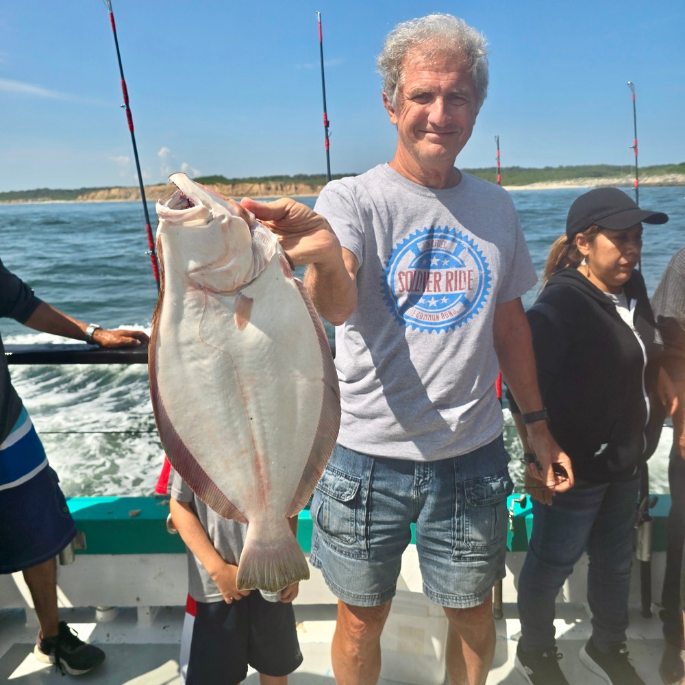 a person holding a fish in the water