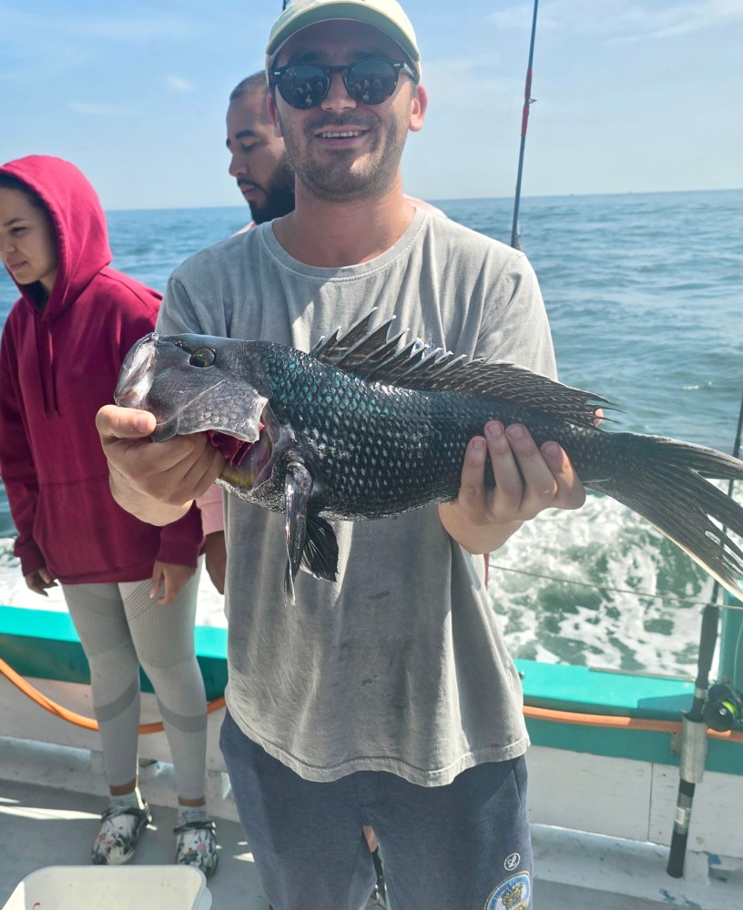 a person holding a fish in the water