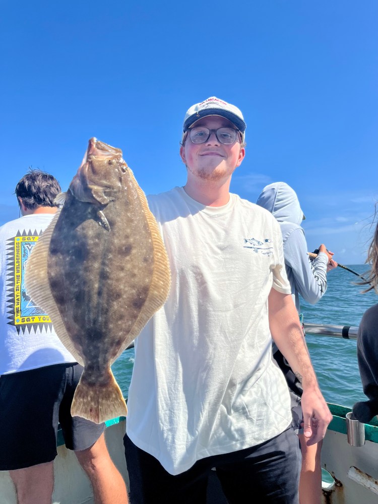 a man holding a fish