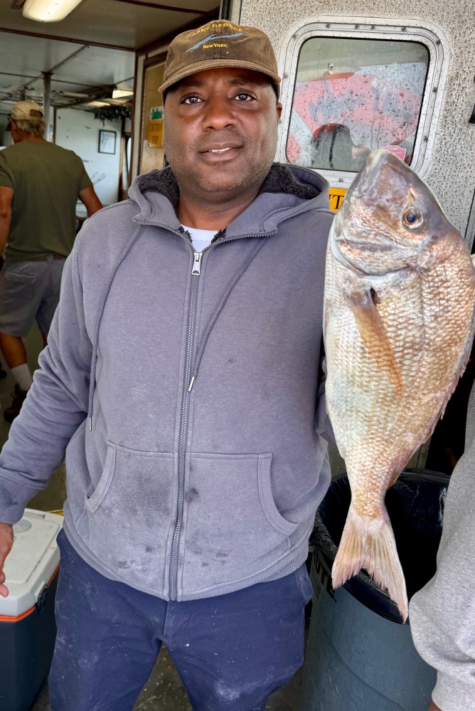 a man holding a fish