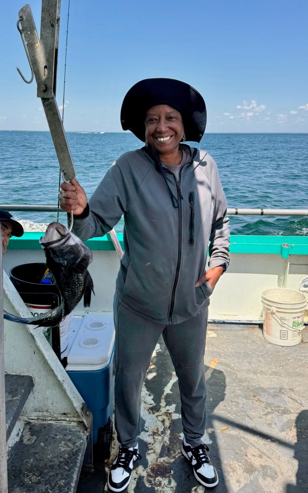 a person standing next to a body of water