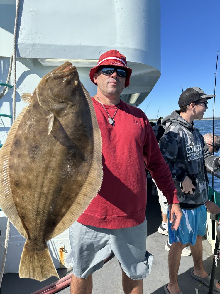 a man holding a fish