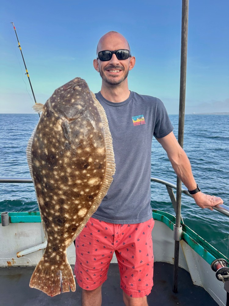 a man holding a fish in the water