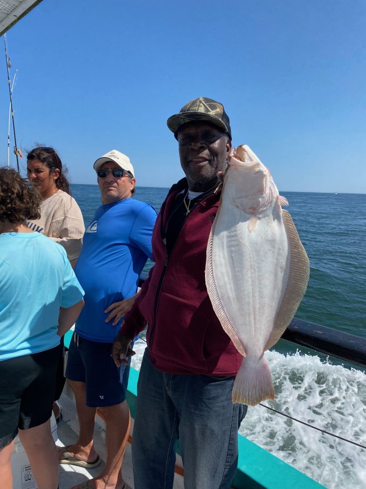 a person holding a fish in the water