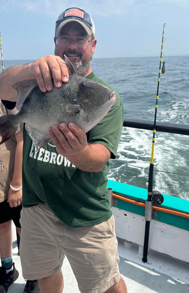 a person holding a fish in the water