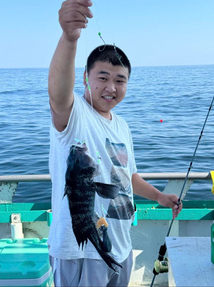 a man holding a fish in the water