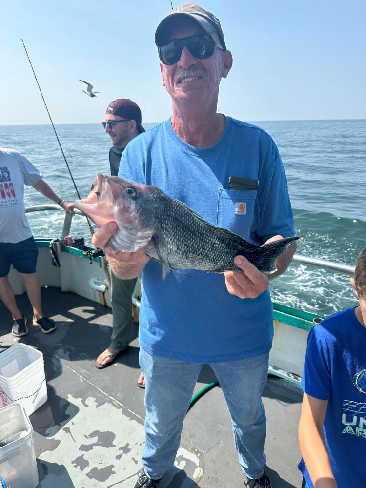 a person holding a fish in the water