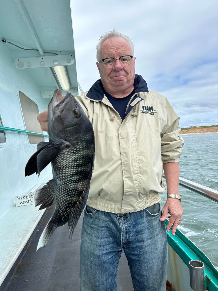 a man holding a fish in the water