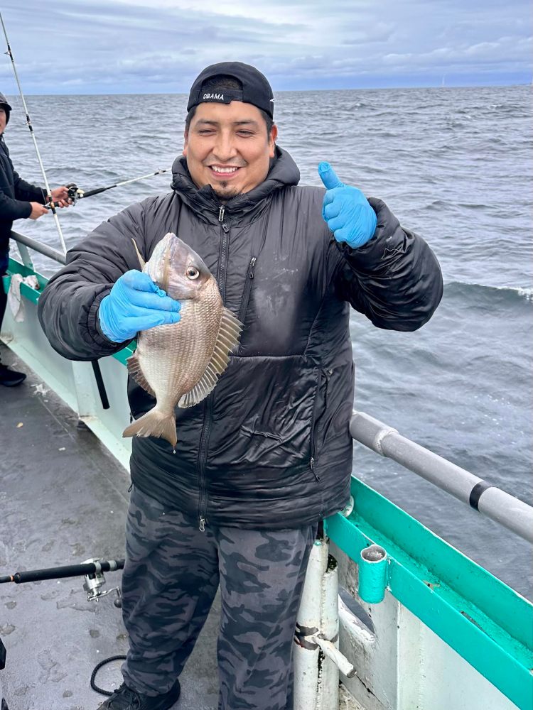 a person standing next to a body of water