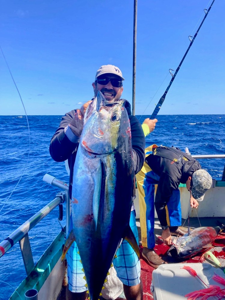 a person holding a fish in the water