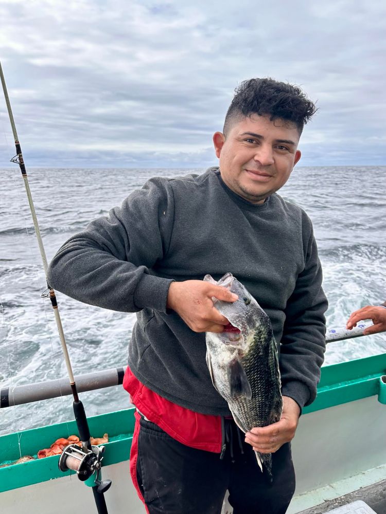 a person holding a fish in the water