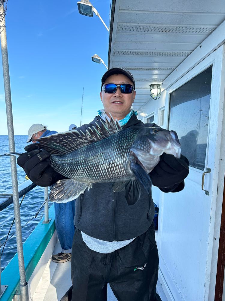 a person holding a fish on a boat