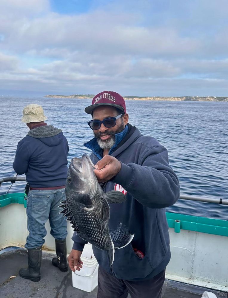 a person holding a fish in the water