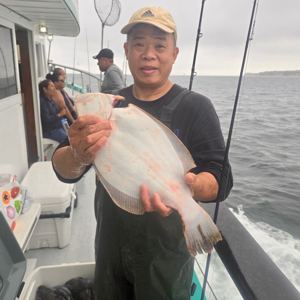 a man holding a fish in the water