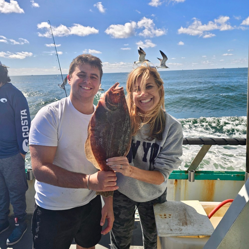 a man and a woman standing next to a body of water