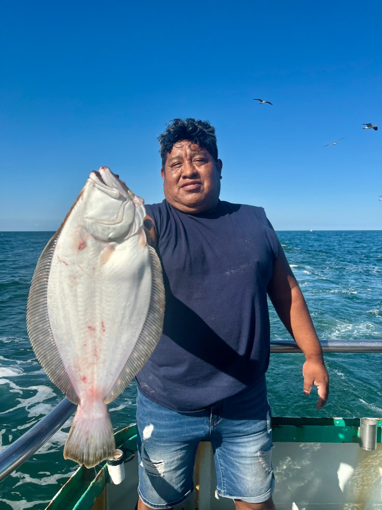 a person holding a fish in the water