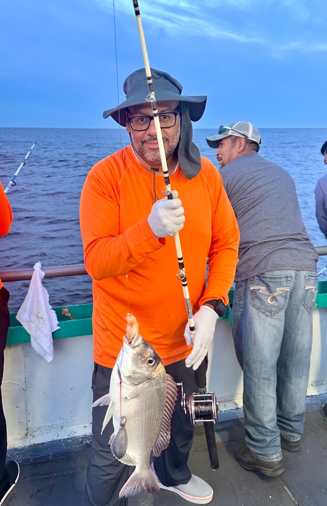 a person holding a fish in the water