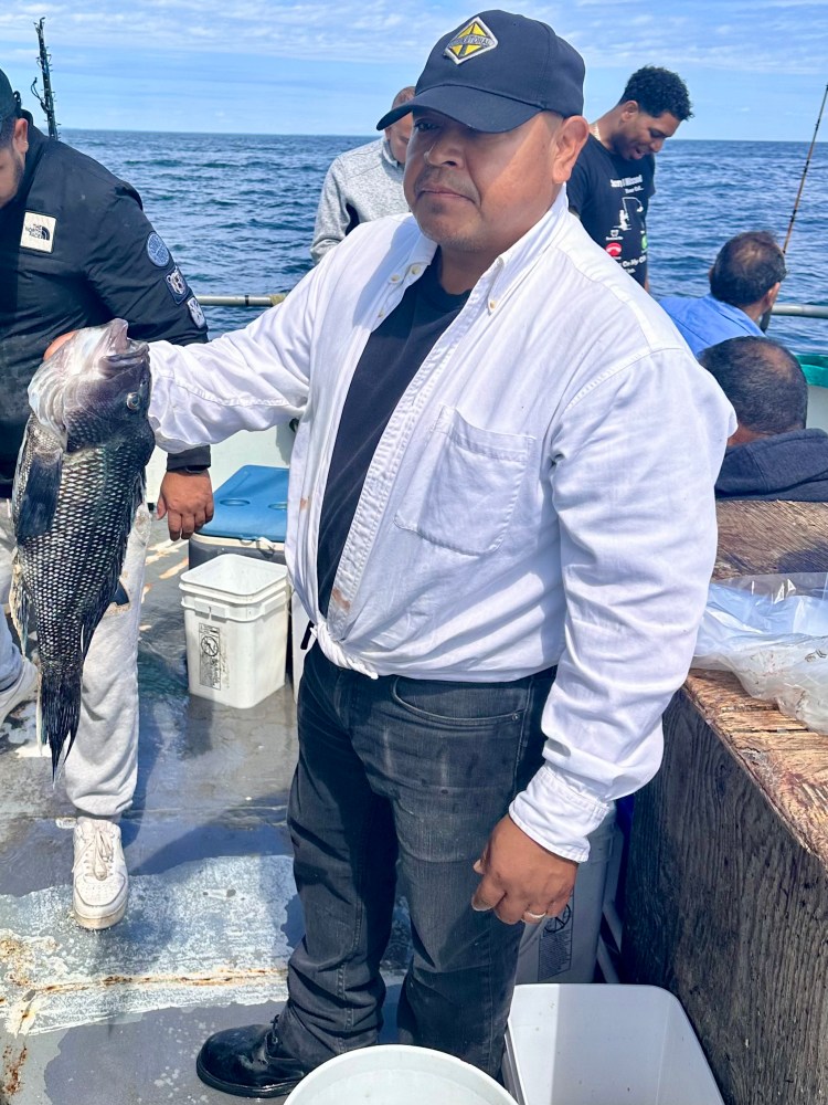 a person holding a fish in the water