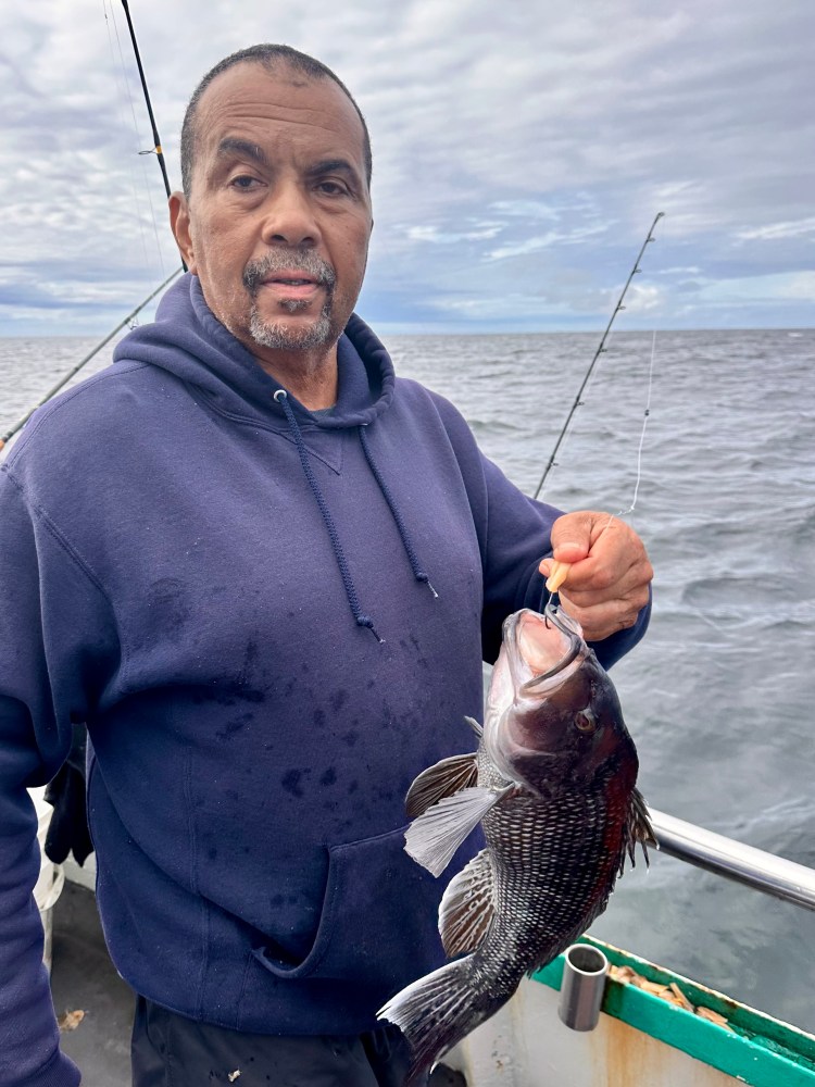 a man holding a fish in the water