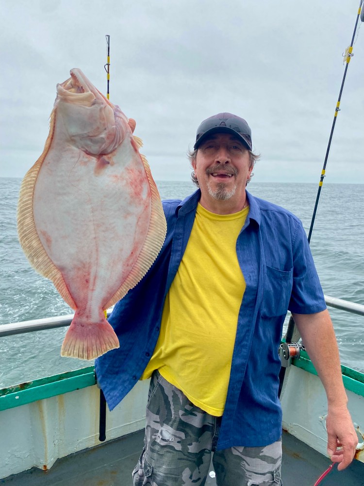 a man holding a fish