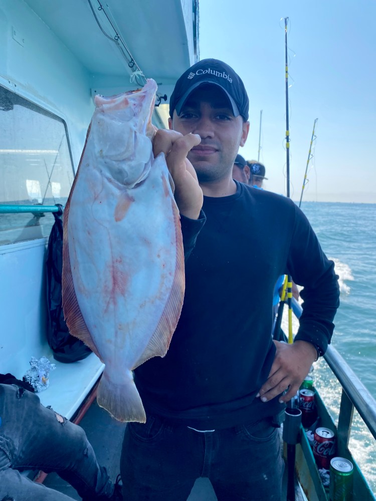 a person holding a fish in the water