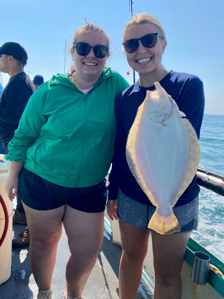 a woman holding a fish