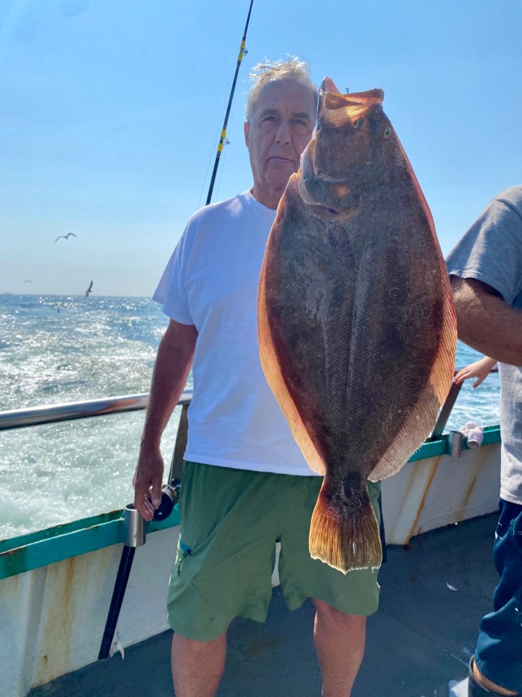 a man holding a fish