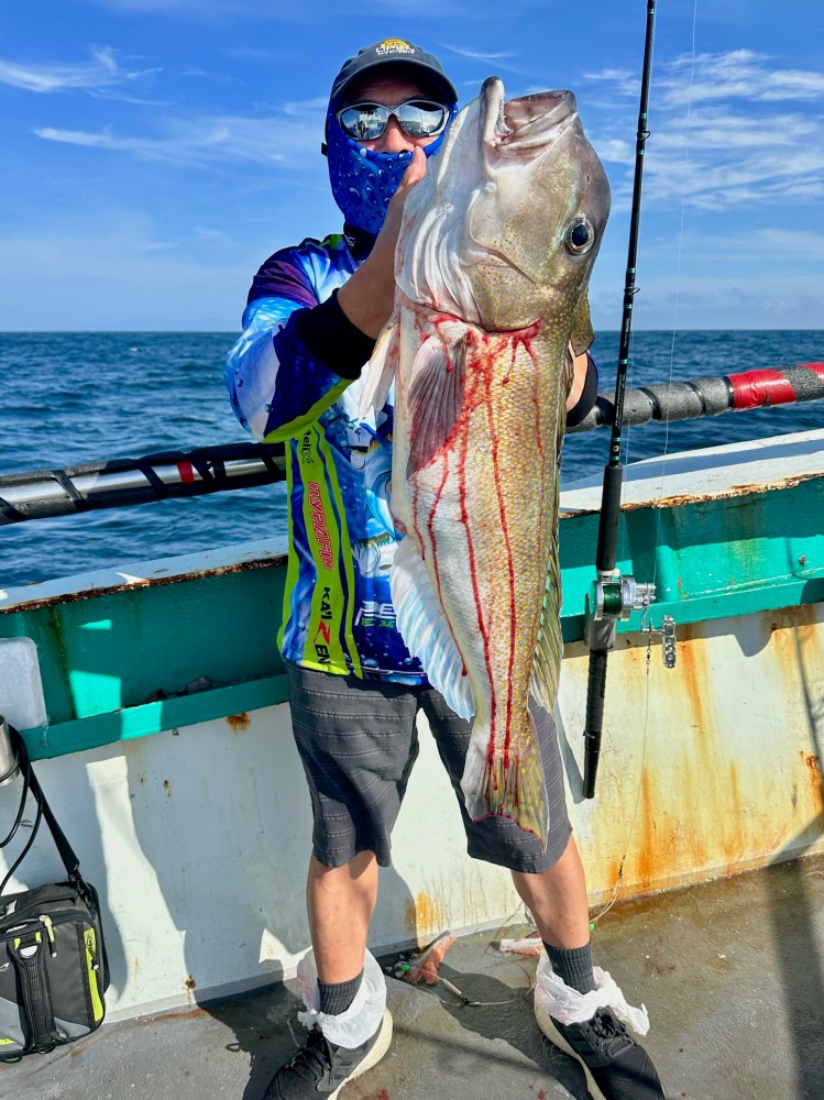 a man holding a fish in the water