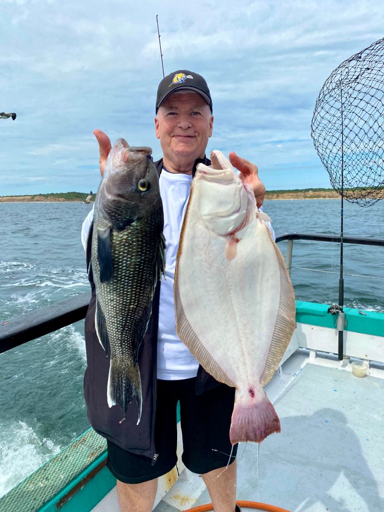 a person holding a fish in the water