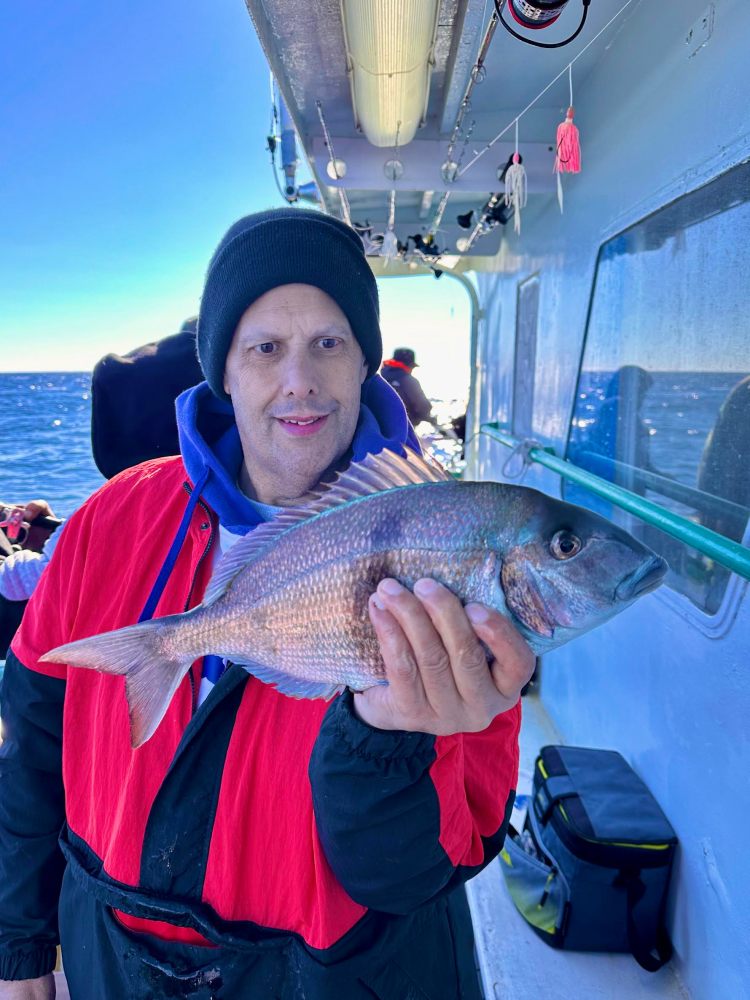 a man holding a fish