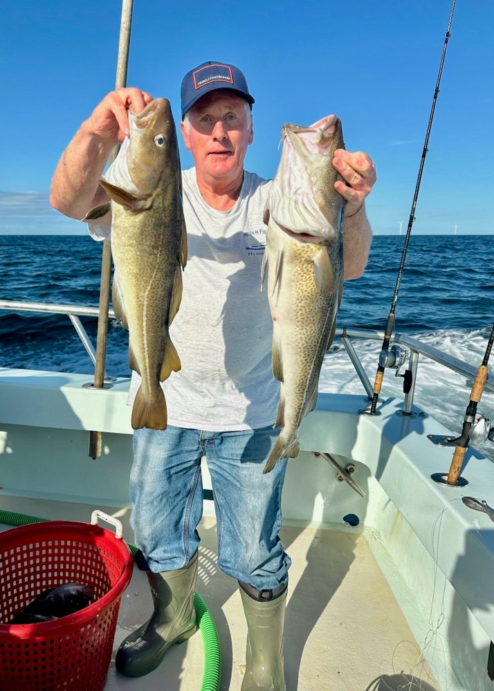 Butch Hobson holding a fish on a boat