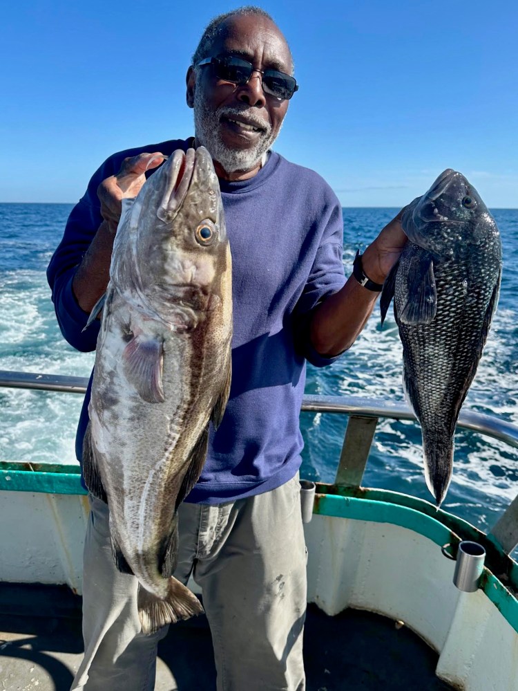 a man holding a fish in the water