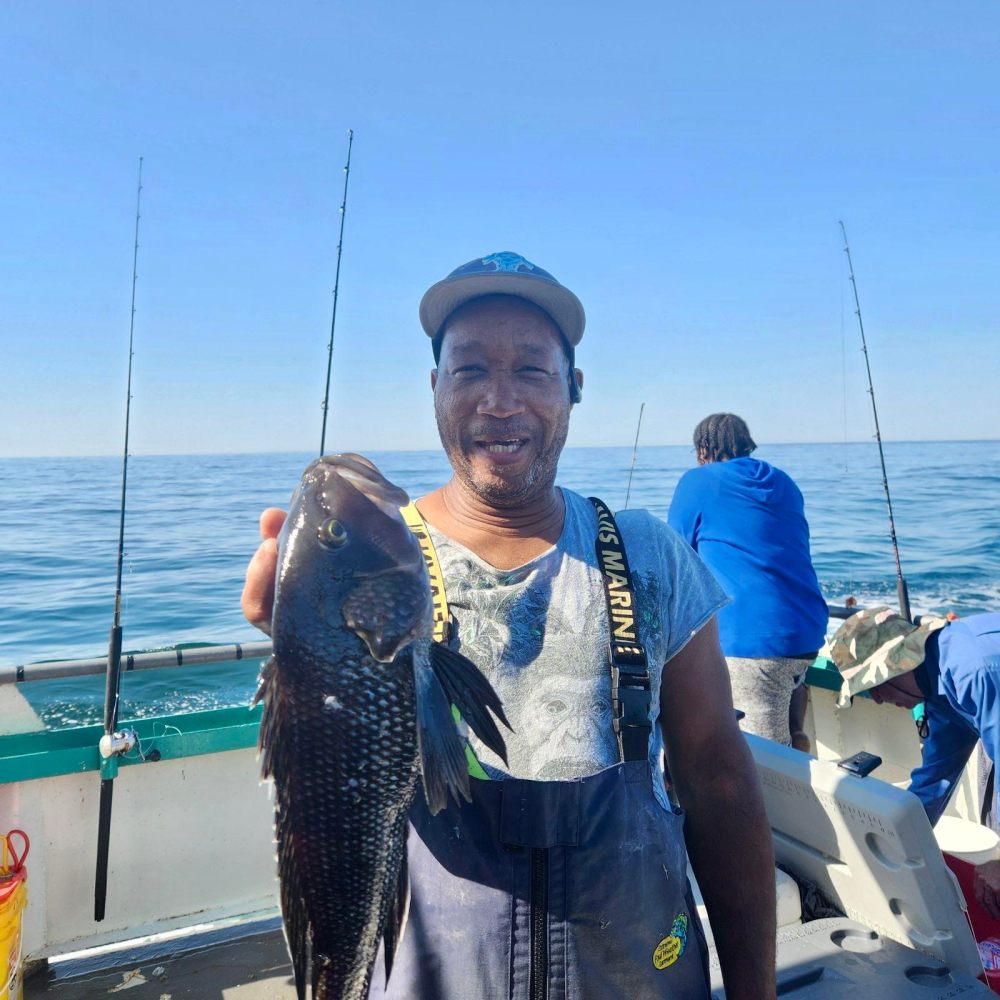 a person holding a fish in the water