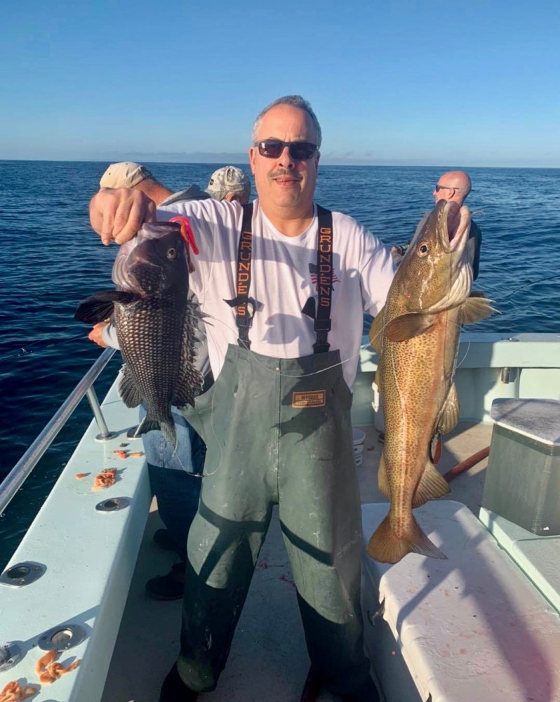 a man holding a fish in the water