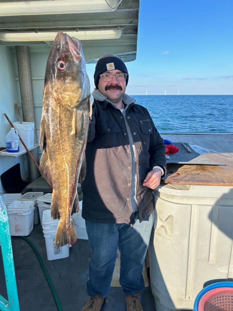 a person holding a fish in the water