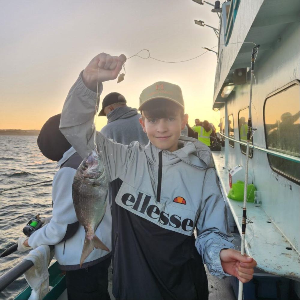 a person holding a fish in the water