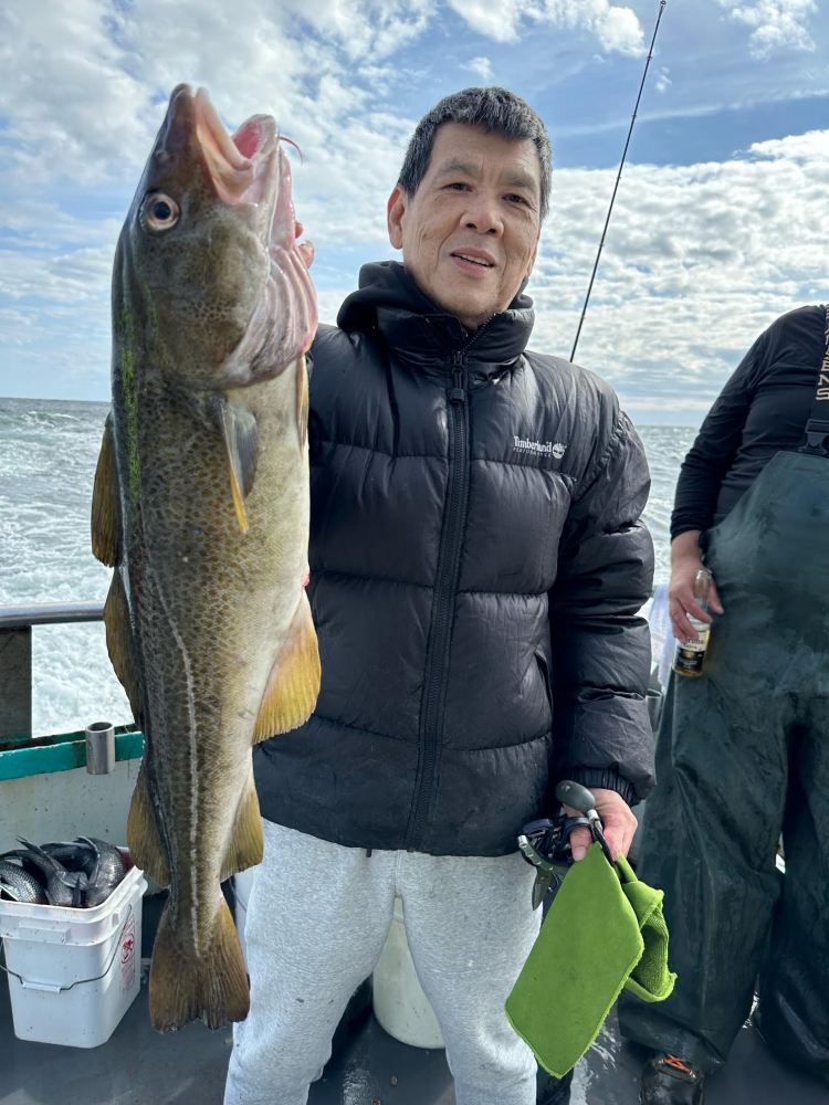 a couple of people that are standing in front of a fish