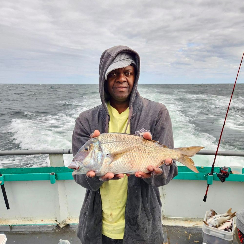 a person holding a fish in the water