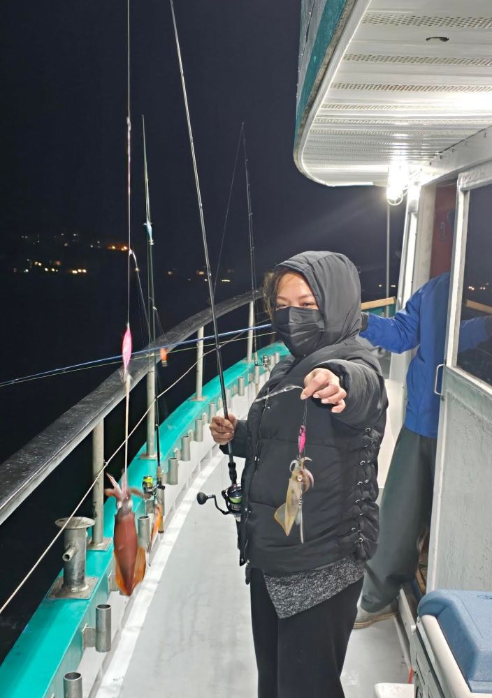 a person standing next to a boat