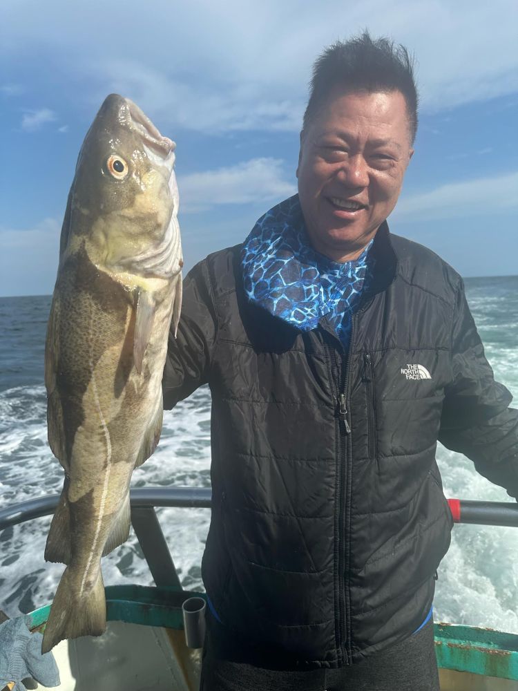 a man holding a fish in the water