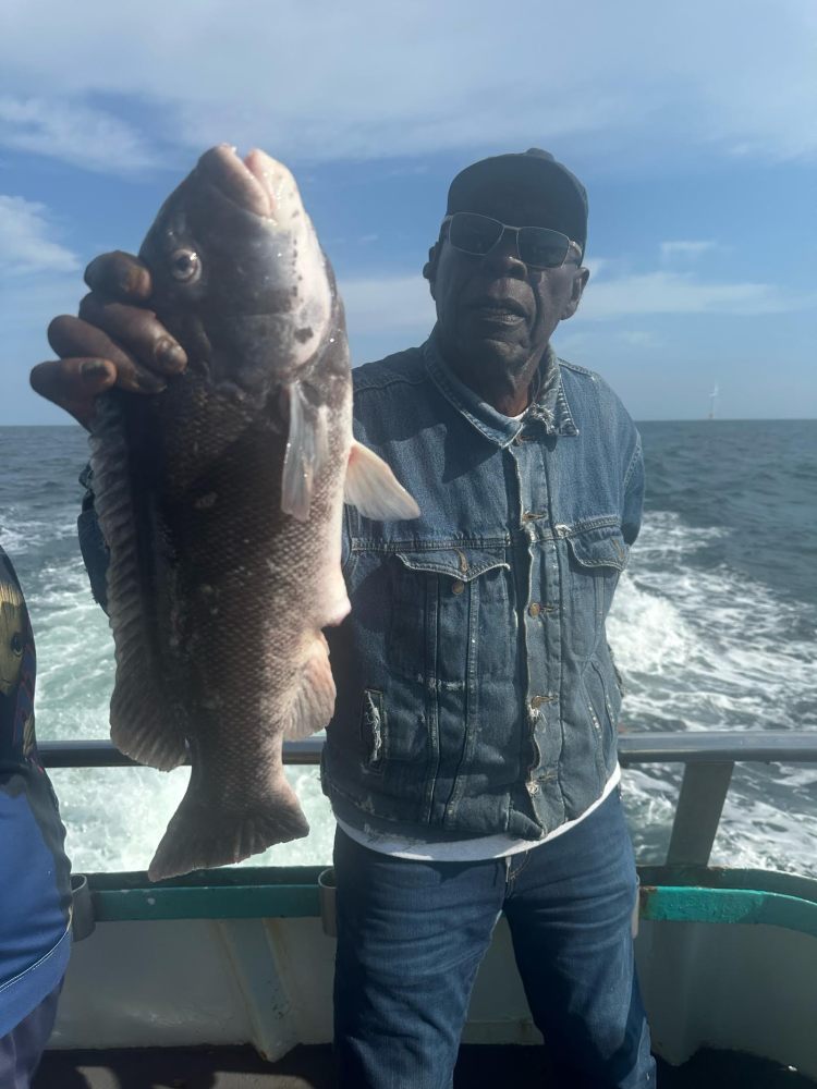 a man holding a fish in the water