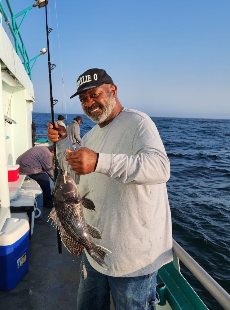 a man holding a fish in the water